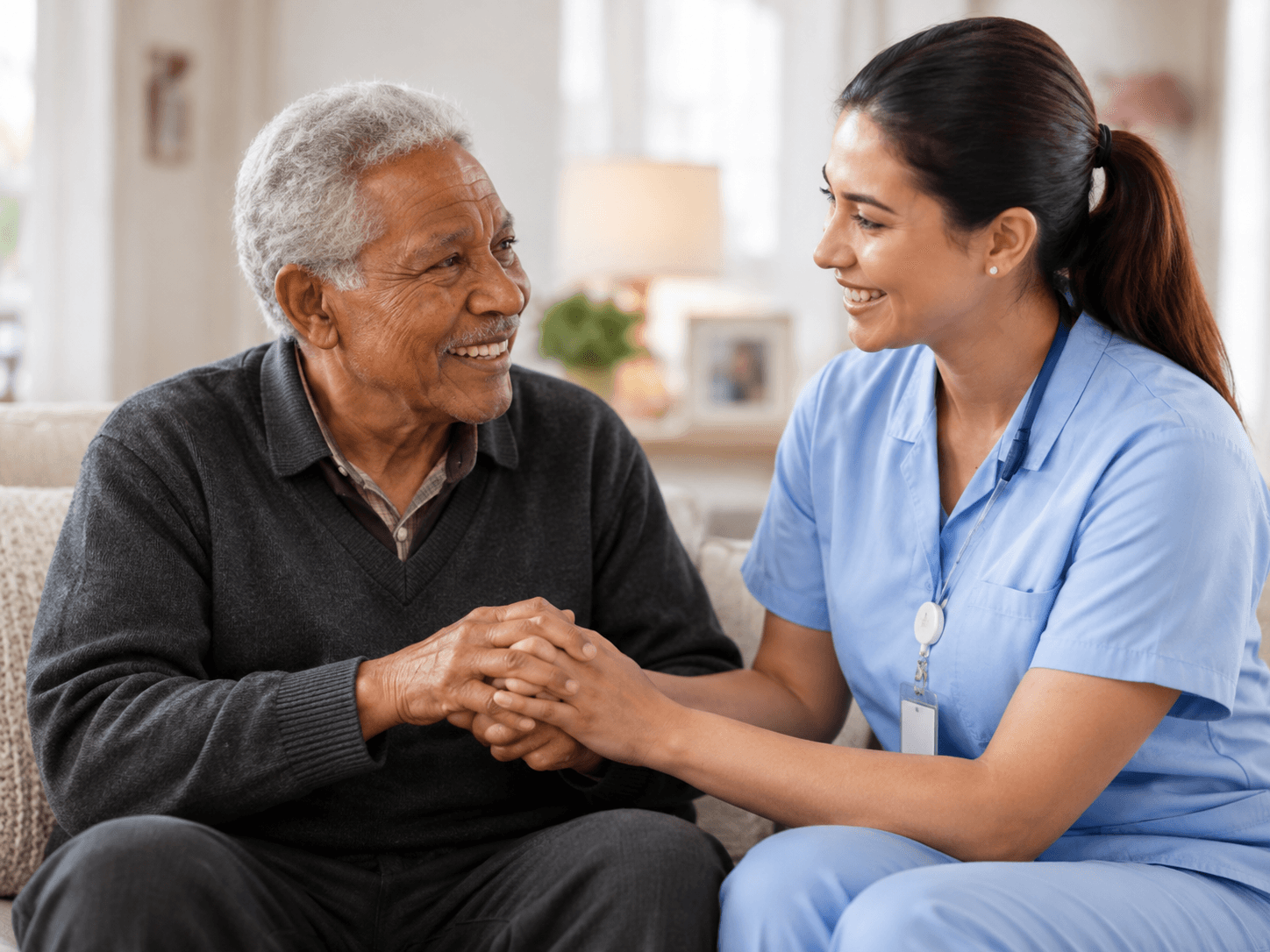 A nurse speaking with an older man at home